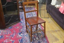 A 1920s stained child's school chair with spar back and shaped seat, on turned supports (h. 73cm x