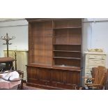 A 19thc mahogany two part upright open bookcase, the moulded cornice above an arrangement of
