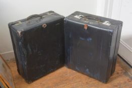 A pair of vintage blue fibreboard travelling cases, with leather handles and stencilled initials.