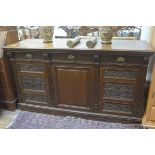 An Edwardian oak sideboard, the rectangular top with moulded edge above three frieze drawers, with