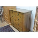 An Edwardian oak chest, with two short and three long drawers, on fluted side supports with original