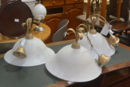 A set of three modern opaque flared pendant light fittings with gilt fleur de lys style tops (h.30cm