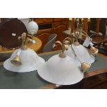 A set of three modern opaque flared pendant light fittings with gilt fleur de lys style tops (h.30cm