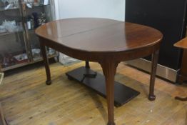 A Whytock & Reid wind out mahogany dining table in the Georgian taste, the moulded top with bowed