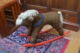 A plush child's miniature rocking horse raised on red scroll rockers (h.54cm x 69cm)