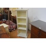 A white finish painted upright open bookcase with three adjustable shelves. 118cm by 45cm by 26cm