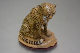 A pottery handpainted model of a Cheetah, unsigned (h.16cm)