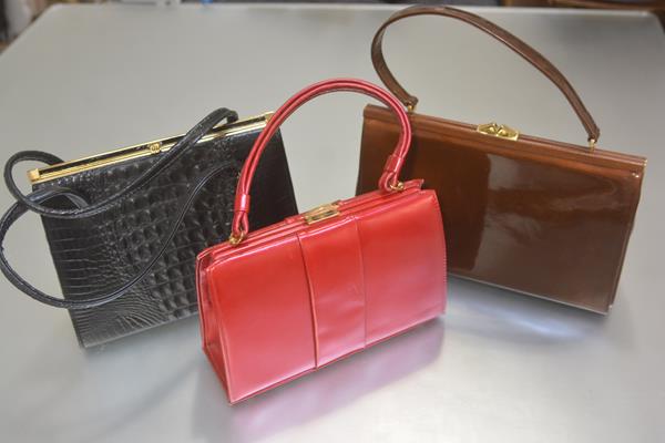 A lady's black mock crocodile skin two handled vintage handbag, a suede lined pink lustre two