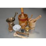 A collection of four various treen mortars and pestles, a gilt metal enamelled mortar and pestle,
