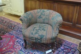 A neat 19thc. scroll back nursing style chair with tapestry upholstery, on scroll supports (h.60cm)