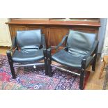 A pair of Arkana English ebonised and black vinyl upholstered back and arm chrome support easy