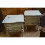 A pair of American cream finish bedsides with scalloped tops, fitted two drawers, raised on carved