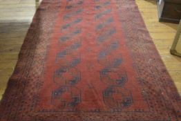 A Bokhara rug, the centre panel with two rows of eight octagons enclosed within a multiple