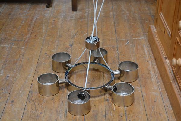 A 1970's stainless steel finish circular pendant light fitting with six circular light pods with