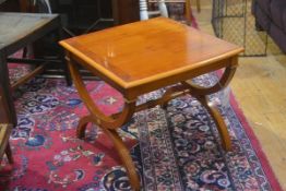 A yew wood lamp table, the square top with crossbanded and ebony strung border, raised on X frame