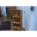 A hardwood upright three tier etagere, shelves with fluted edge and x-framed side supports. 120cm by