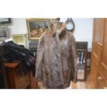 A Jenners lady's ranch mink fur jacket with belt, with satinised lining and slash pockets to side (