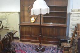 A walnut turned wood and fluted floor lamp raised on circular moulded base, complete with shade (h.