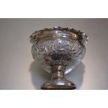 An Indian plated chased scalloped border rose bowl decorated with scenes of hunting and tigers,