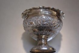 An Indian plated chased scalloped border rose bowl decorated with scenes of hunting and tigers,