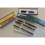 A collection of late 20thc Waterman fountain pens, a Laureat blue marble (boxed) pen and