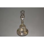 An Epns bell with earlier Birmingham silver chased and pierced rose and C scroll handle, complete
