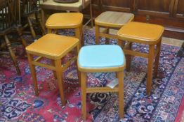 Five Romanian 1950s beech framed kitchen stools with inset vinyl tops (one in brown stripe, one in
