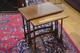 A mahogany nest of two tables, the rectangular tops with inset ebonised border, raised on twin end