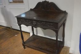 A Victorian carved oak ledgeback hall table, the rectangular top with relief carved border above a