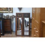 A pair of modern painted wood rectangular panelled mirrors with decorative floral enamelled and