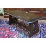 An Ercol style dark oak rectangular coffee table, raised on pierced shaped end supports (h.43cm x