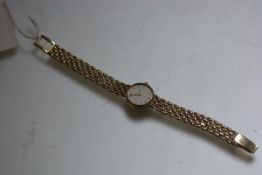 A lady's 9ct gold Record Deluxe quartz wristwatch with silvered dial and lozenge hour markers, on