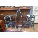 A pair of late 19thc/early 20thc cast wrought iron garden bench ends of vine, fruit and leaf design,
