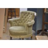 A Victorian walnut framed button back tub chair with upholstered back, arms and seat, in green