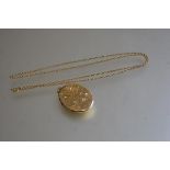 A 9ct gold trace link chain with a 9ct gold engraved oval locket, inscribed verso: l.30cm (4.75g)