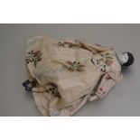 A 19thc china miniature doll with contemporary printed cotton dress, complete with bloomers, with