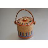A Japanese porcelain Thousand Face pattern biscuit barrel with bamboo swing handle to top (h.13cm)