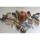 A collection of pipesmoking related items including a tobacco jar, a collection of treen carved
