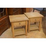 A pair of oak bedsides with square tops fitted open shelves and undershelf, on square moulded