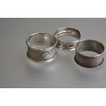 Three various Birmimgham silver napkin rings with engine turned and chased decoration (3)