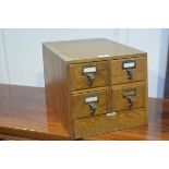 A 1920s oak four drawer index box by Libraco, London, with ivorine panel to slope front (h.29cm x
