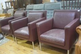 A set of three Walter Knoll burgundy hide club chairs with squab cushions, on anodised stainless