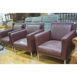 A set of three Walter Knoll burgundy hide club chairs with squab cushions, on anodised stainless