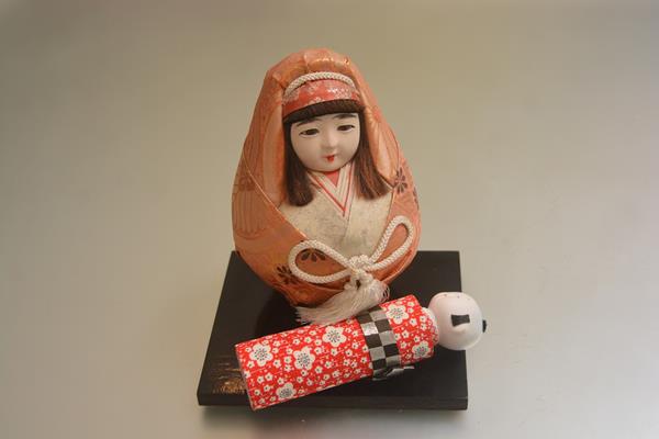 A Japanese Kokeshi style doll and a baby doll complete with hardwood stand (h.18cm and 16cm) (2)