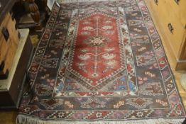 A Milas style Turkish rug, the centre diamond panel with stylised lotus flowers enclosed within a