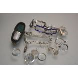 A silver thimble with original case, a white metal blue enamelled bracelet, a silver charm