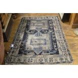 A Kasak rug c.1900 with twin centre medallions enclosed within a bird and animal border, with