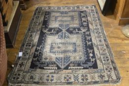 A Kasak rug c.1900 with twin centre medallions enclosed within a bird and animal border, with