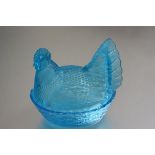 A moulded turquoise glass hen on nest (h.20cm x 22cm x 17cm)