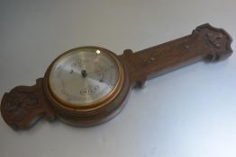 An Edwardian oak carved banjo style wall barometer, retailed by F. Robson & Co., Newcastle upon